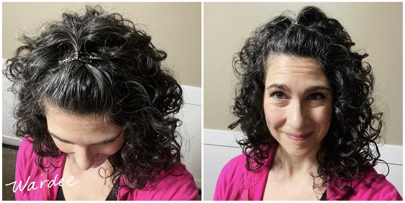 shot of a woman with dark curly hair using a non-damaging hair clip
