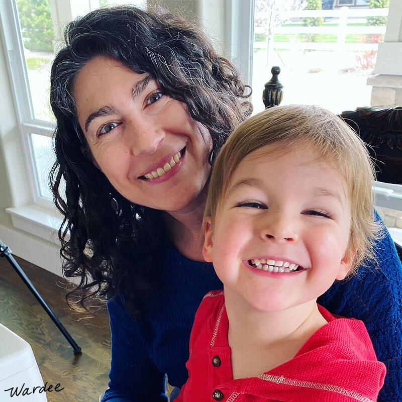 smiling woman and small boy on her lap