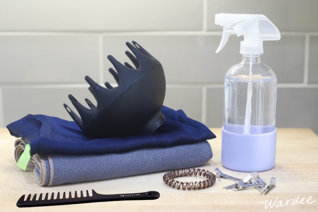 Hair styling products sitting on a bathroom counter.