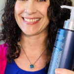 Photo of smiling woman with bottle of shampoo. Text overlay says: "Restore Soft, Shiny Hair with Clarifying Shampoo (+best routines for all hair types)"