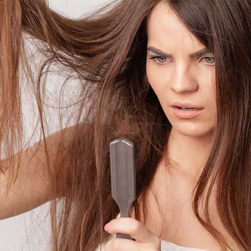 Brunette woman dissatisfied with her hair.
