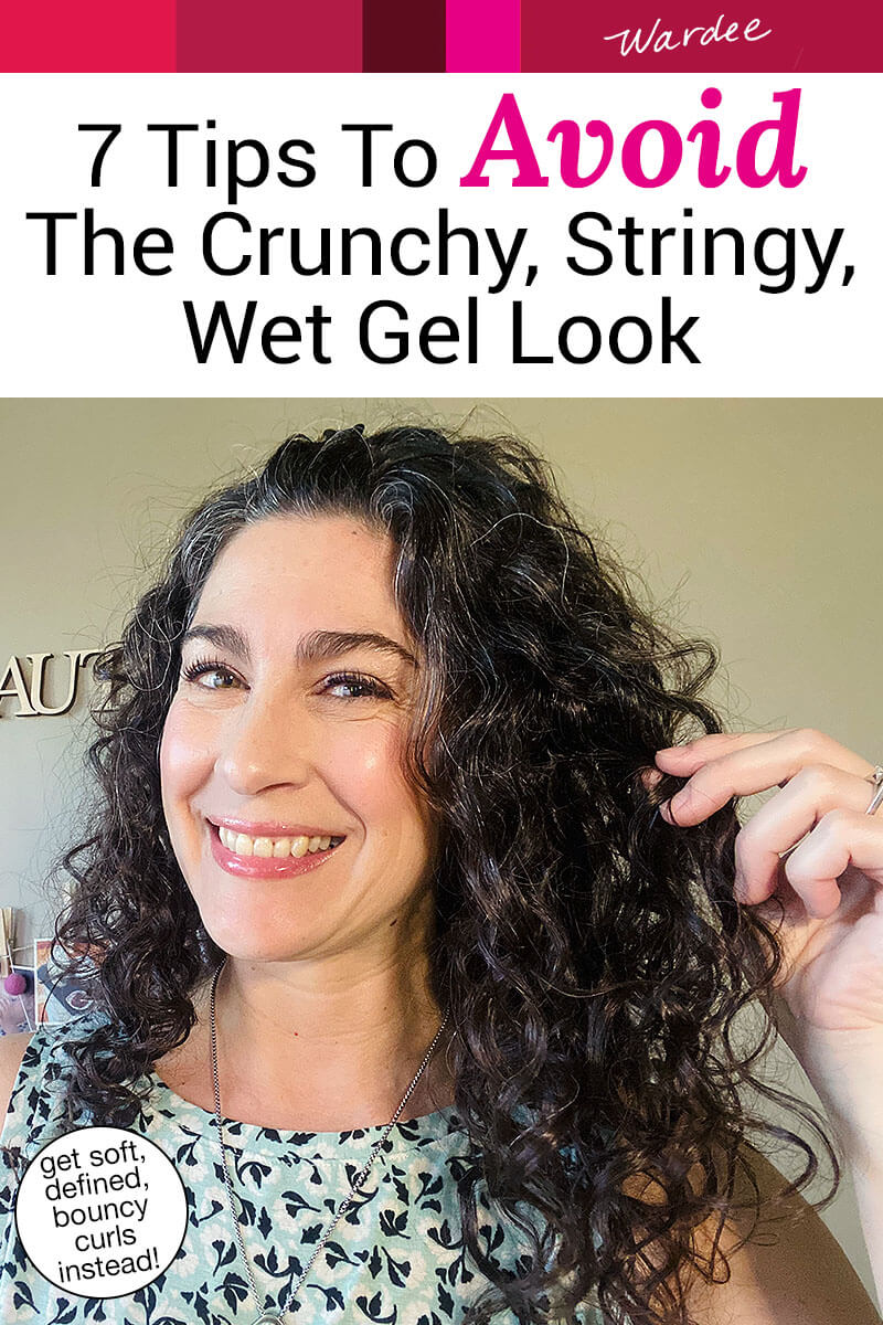 Smiling woman holding up her curls. Text overlay says: "7 Tips to Avoid the Crunchy, Stringy, Wet Gel Look (get soft, defined, bouncy curls instead!)"
