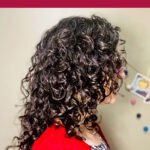 A photo of a woman in profile with curly hair. Text overlay says: "How to Diffuse Hair for Volume At Roots (neck-safe routine for bouncy curls)"