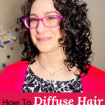 Smiling woman with bright pink glasses and dark curly hair. Text overlay says: "How to Diffuse Hair Without Flipping Your Head Upside Down (without having to tip head upside down... neck safe routine)"